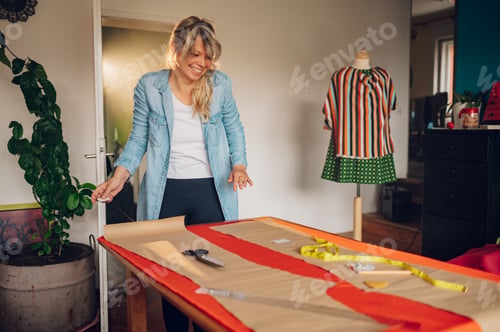 Preview: Woman tailor working from home and tailoring beautiful clothes