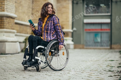 Preview: Woman with disability using a smartphone while out in the city