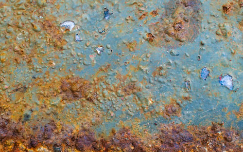 Preview: rusting old metal plate painted with blue paint