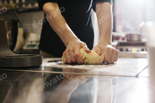 Preview: Close up. The cook kneads the dough with his hands, making macaroons or cakes.