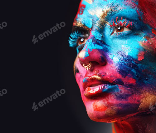 Vista previa: Shot of an attractive young woman posing alone in the studio with paint on her face