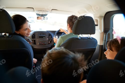 Preview: Young white family making a trip in their car, close up, back view car interior shot