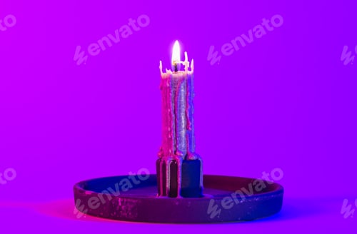 Preview: Texture vintage candle on a pink background with neon lighting, copy space.