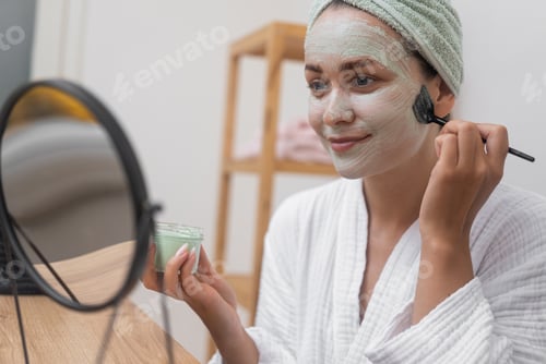 Preview: Woman Applies Facial Mask with Brush at Home