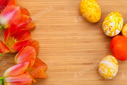 Preview: Easter eggs with tulips on wooden board, easter holiday concept. Copyspace for text