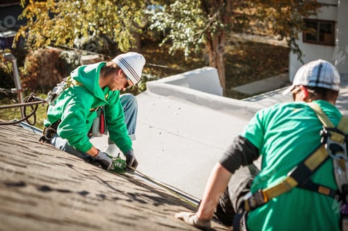 Preview: Solar panel installation crew members on roof of house