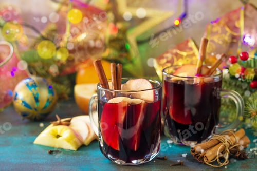 Preview: Christmas Mulled wine or sangria with spices. Two glasses of hot mulled wine with apple and spices.