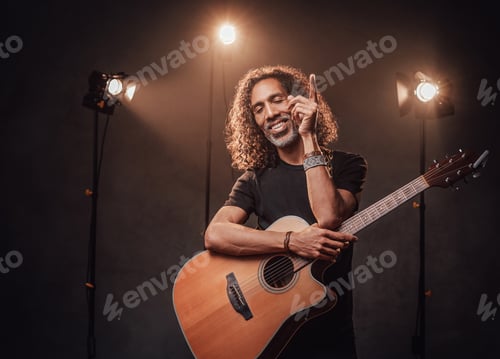 Preview: Guitar Player with Curly Hair Performing Under Lights