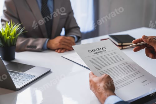 Preview: An employer interviewing for a job or head of HR is reading a resume while discussing the resume. An
