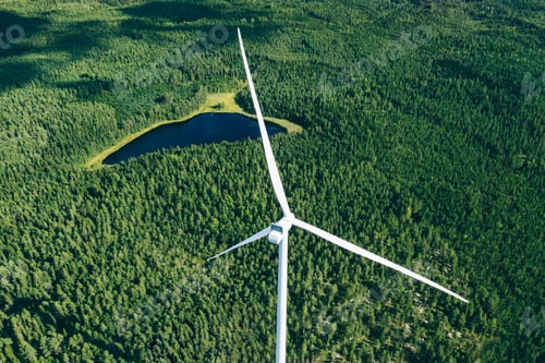 Preview: Windmills, wind turbines. Aerial view of windmills in green summer forest in Finland.
