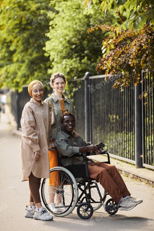 Preview: Smiling interracial friends with man in wheelchair