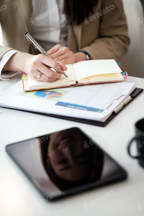 Preview: Woman hand using pen writing on notebook