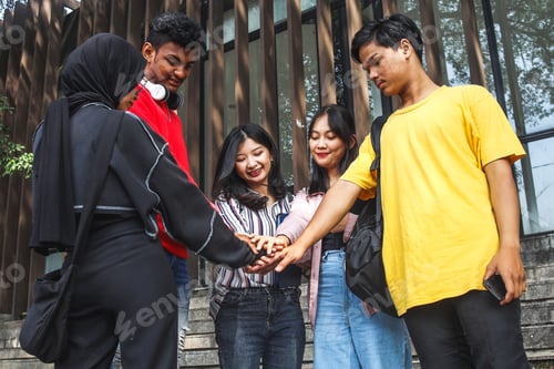 Preview: Diverse group of college students doing high five