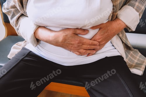 Preview: old woman in hospital reception with stomach ache