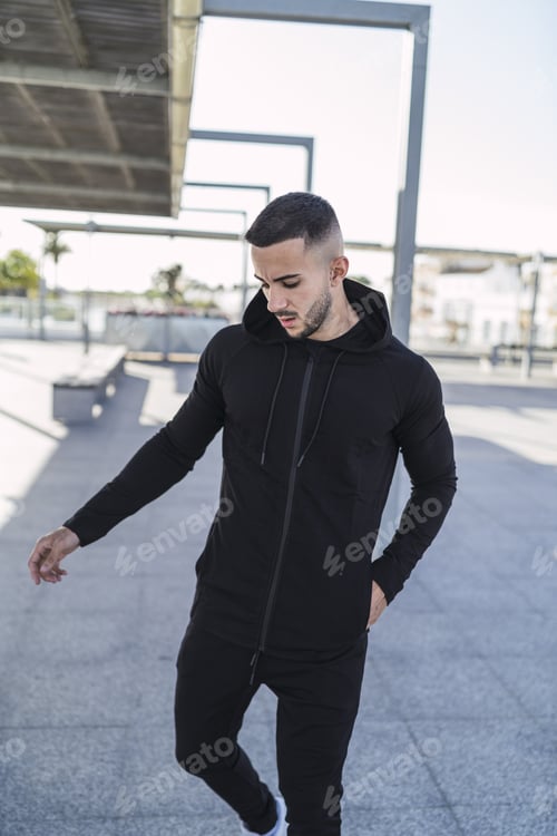Preview: Young man in cool casual style posing outdoors
