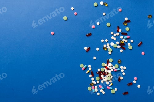 Preview: assorted pills and tablets top border over colored background. Many different pills