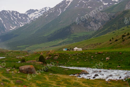Preview: Mountain valley landscape with stream, yurts, and a herd of sheep