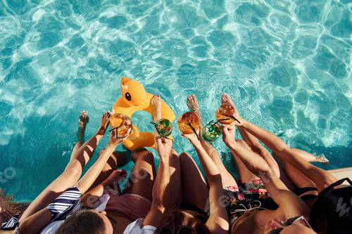 Preview: Top view of group of young happy people that have fun in swimming pool at daytime