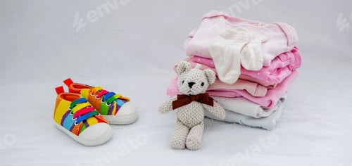 Preview: Children's things on a light background. The concept of baby clothes