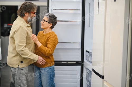 Preview: Senior couple choosing new refrigerator in appliance store