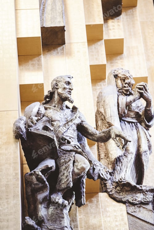 Preview: Vertical shot of a religious statue on the wall of the church
