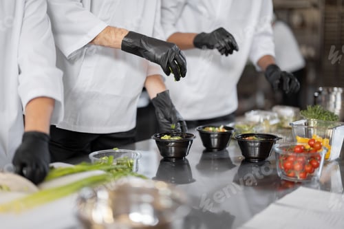 Preview: Chefs prepare takeaway food in professional kitchen