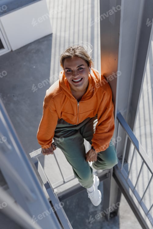Preview: Young Woman Enjoying Sunlight on Urban Staircase