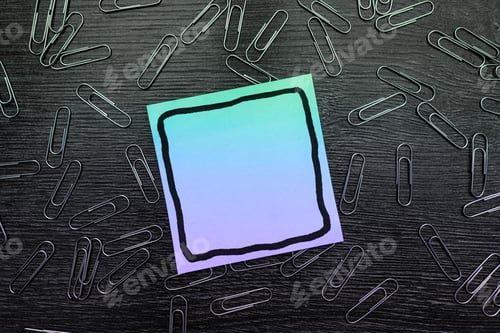 Preview: Close-up of metal binders with a green-to-purple gradient post-it note, with copy space