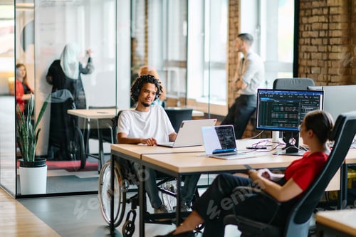 Preview: A young business group, including an African American businessman in a wheelchair, collaborates