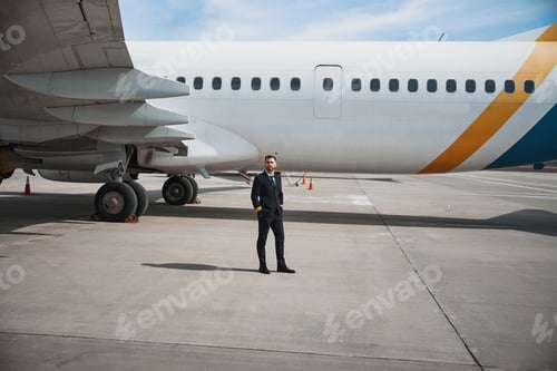 Preview: Pilot posing for photo next to his aircraft