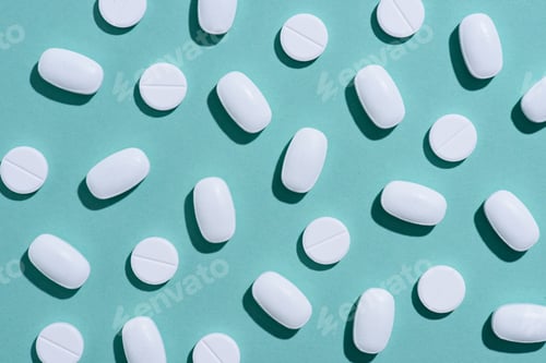 Preview: top view of white pills on blue surface