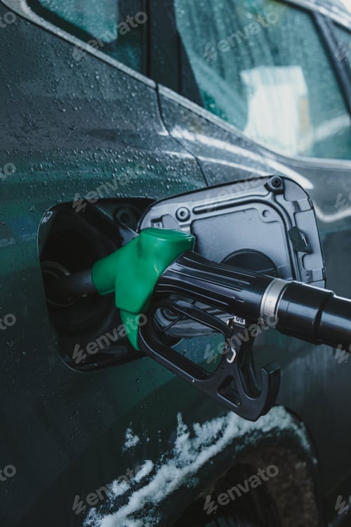Preview: gas pump nozzle in car's fuel tank.