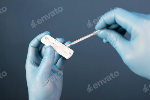 Preview: Doctor with laboratory COVID-19 test kit for diagnosis coronavirus infection.