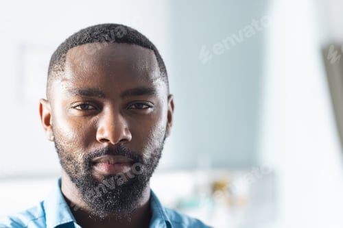 Preview: Portrait of african american male doctor in sunny hospital room