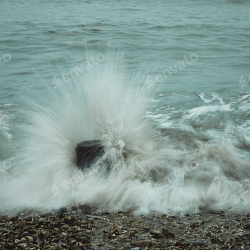 Preview: Long exposure shot of waves rolling onto a stony shore