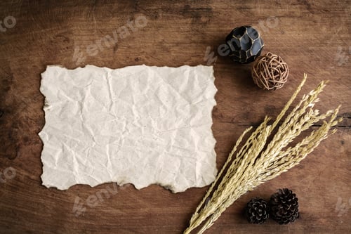 Preview: old wrinkld paper on old wood background with dried flower