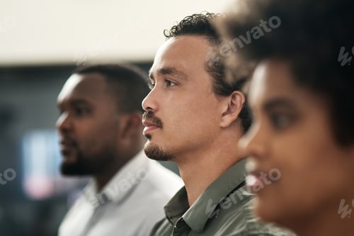 Preview: Shot of a handsome young businessman standing in the office with his coworkers