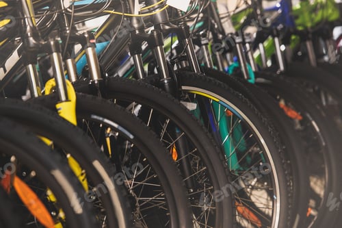 Preview: close-up view of wheels of bikes selling in bicycle shop