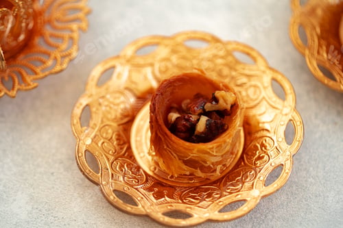 Preview: Turkish baklava and Turkish tea in oriental dishes on gray background