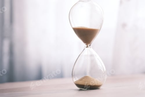 Preview: hourglass on table, sand flowing through the bulb of sandglass