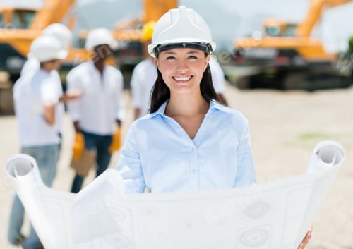 Preview: Female Architect At A Construction Site Holding Blueprints