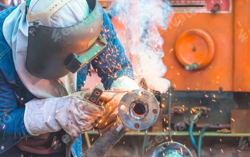 Preview: Welder is welding metal flange to connect with steel pipe for use in improving oil pipeline system