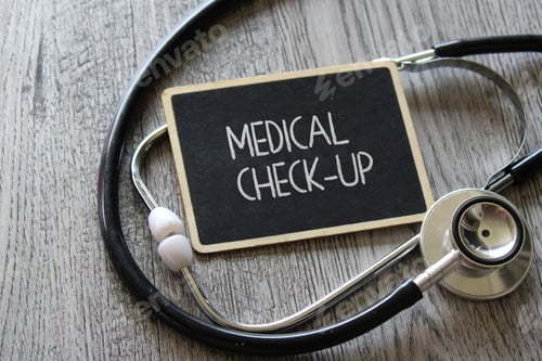 Preview: Stethoscope and chalkboard with text MEDICAL CHECK-UP on wooden table