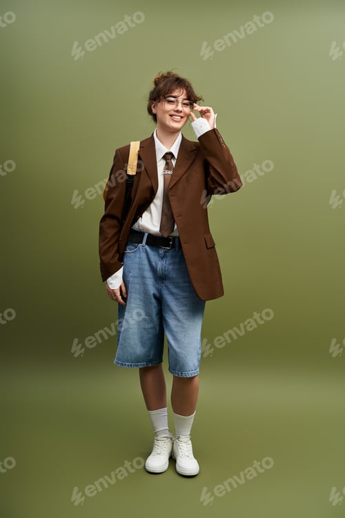 Preview: Young woman radiates confidence in creative fashion choice during a studio portrait session