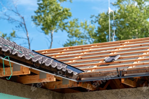 Preview: construction of the roof of a new family house on wooden beams made of ceramic tiles