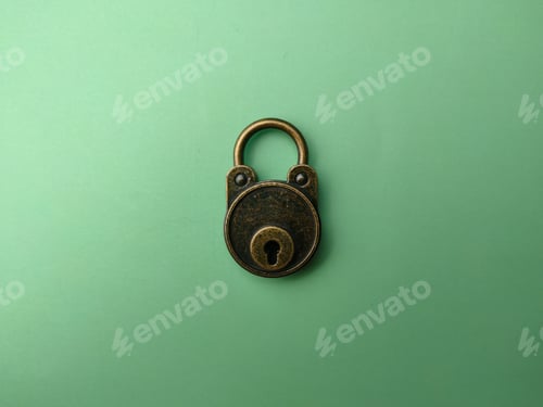 Preview: Bronze vintage padlock on soft green paper background