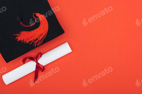 Preview: Top view of academic cap and diploma isolated on red