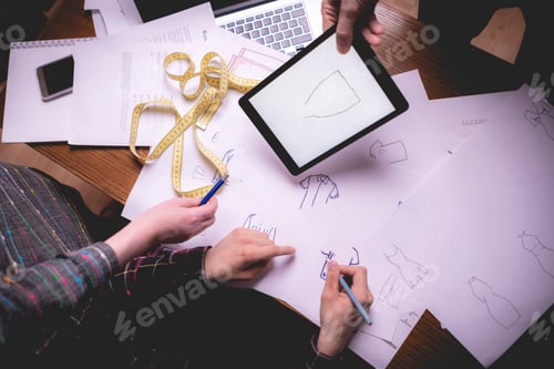Preview: group of tailors designing new clothes in the studio