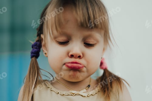 Pouting Child with Tongue Sticking Out