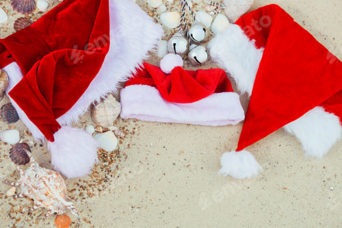 Preview: Christmas hat on the beach. Santa the sand near shells.New year vacation.